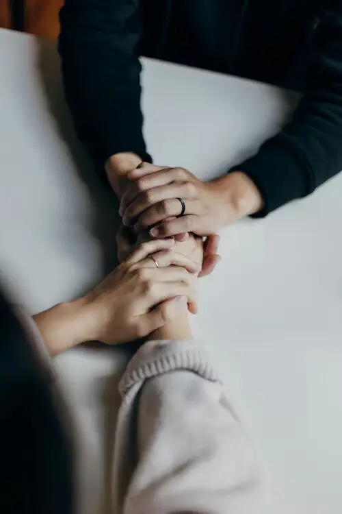 Hands clasped in support
