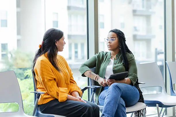 Two practitioners in a supportive conversation